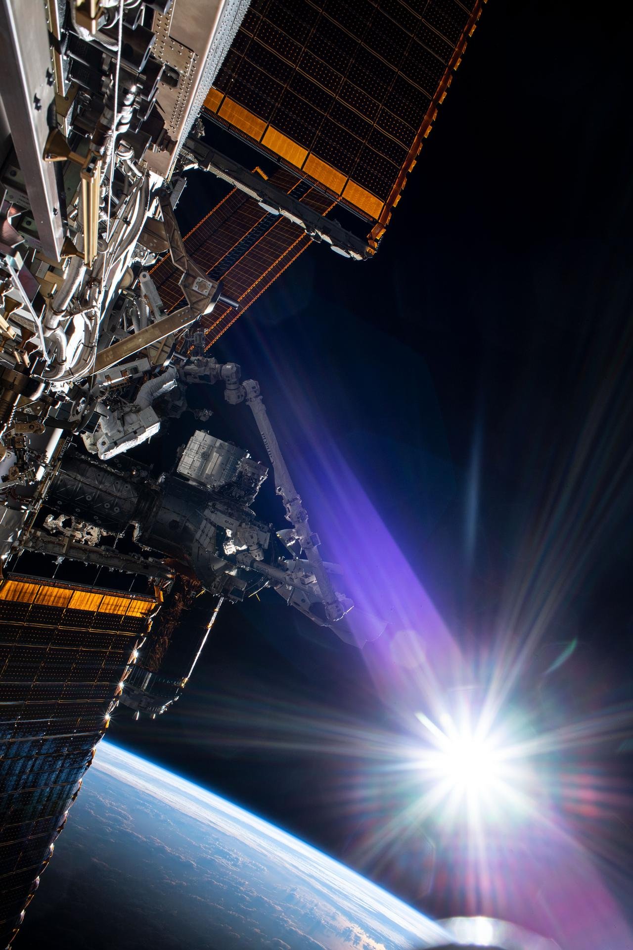 Space station and sunrise over Earth