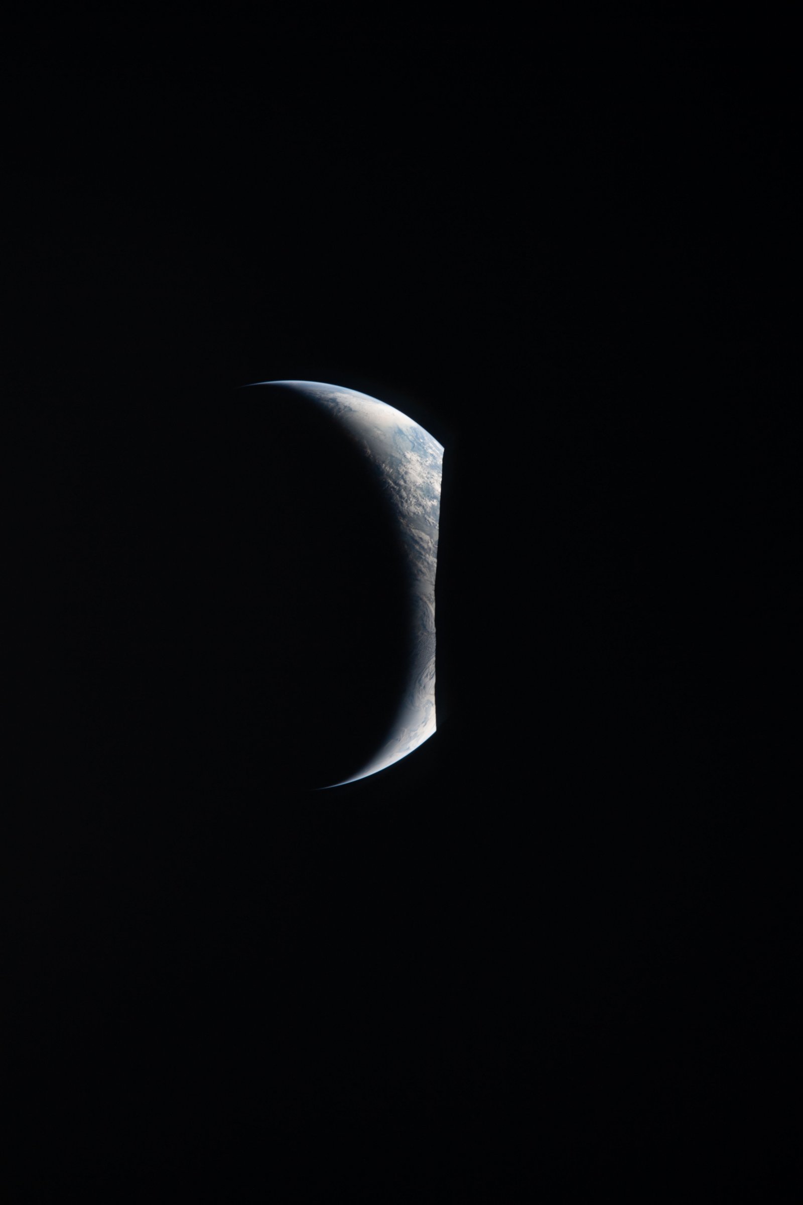 Earth as a thin crescent in deep space
